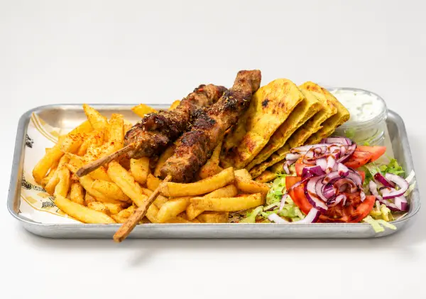 Pork souvlaki skewers with fries, salad and pitta