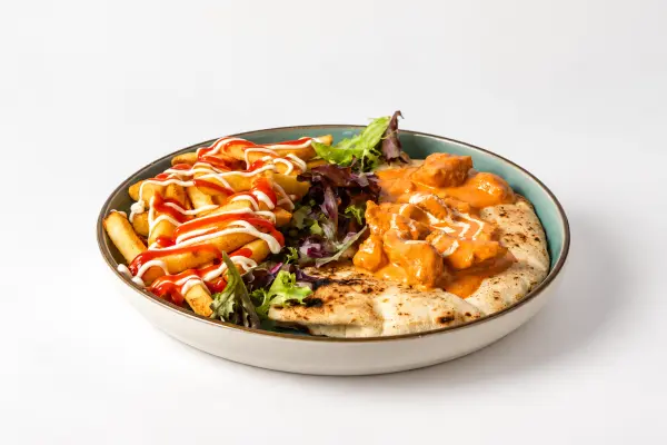 A chicken tikka masala naanwich with salad
